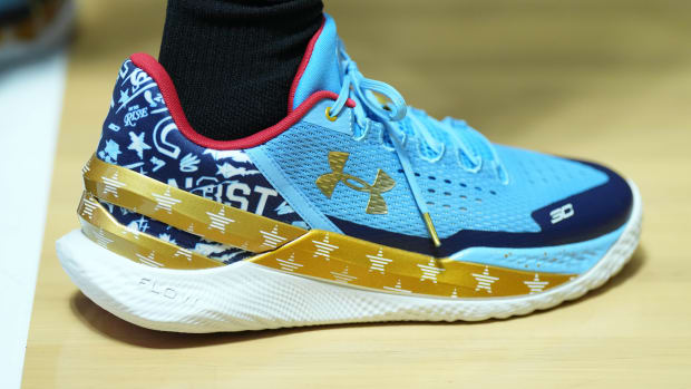 View of De'Aaron Fox's blue and gold shoes.